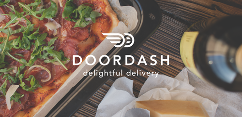 DoorDash logo over a top-down shot of pizza, wine, and a tablet on a table