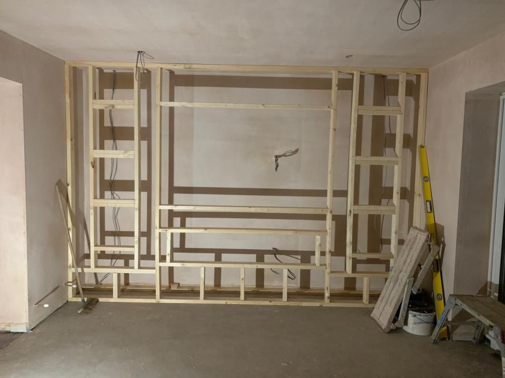 a picture of the studwork for a media wall ready for boarding.
