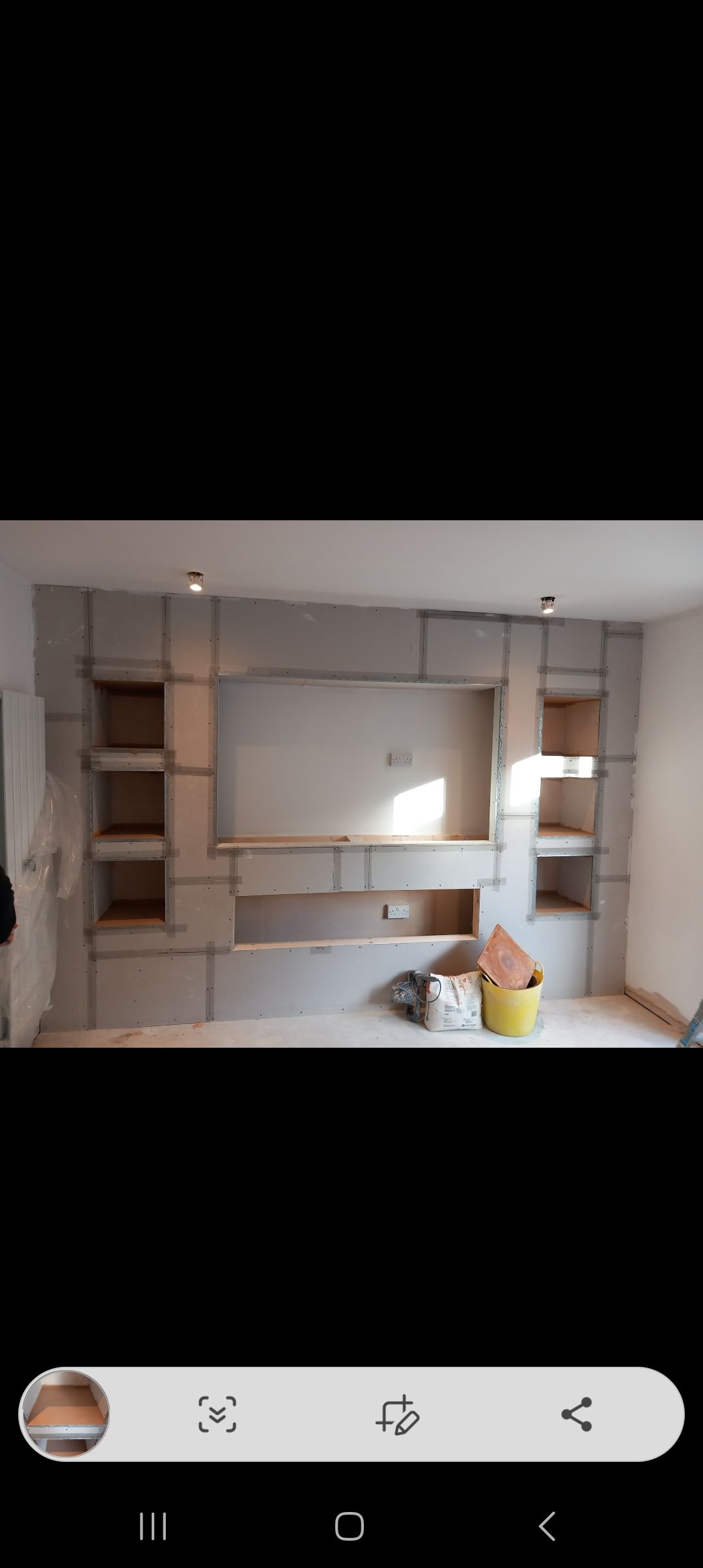 another boarded media wall that spans the entire room
