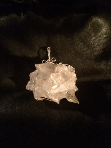 Clear crystal pendant on a dark background