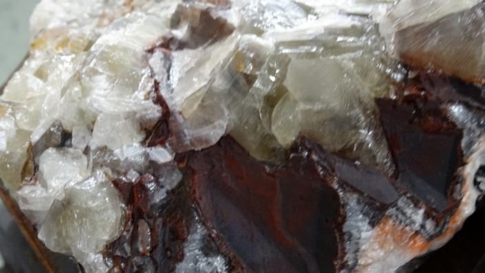 Close-up of translucent white and brown mineral crystals with glossy, jagged surfaces.