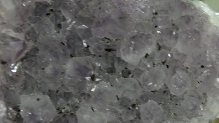 Close-up of rough gray crystal-like stones with a sparkling, textured surface