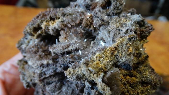 Close-up of a rough gray and brown rock with crystalline textures