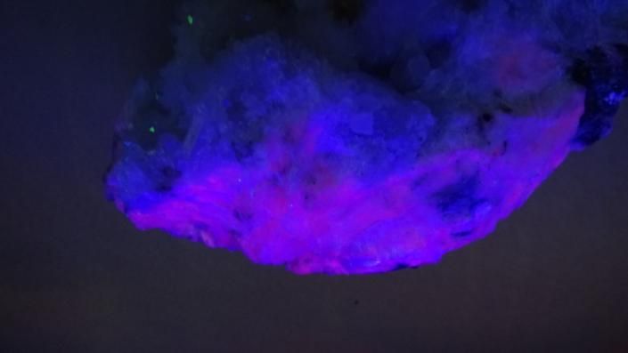 Purple and blue cloud glowing against a dark sky
