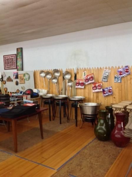 Music room with percussion instruments, chairs, and colorful wall art on a wooden floor