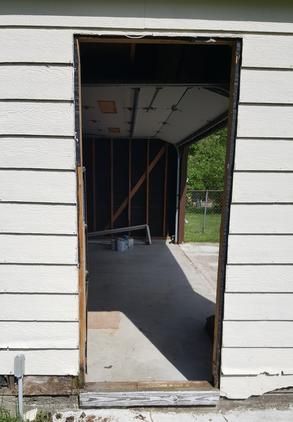 A white house with a door that is open