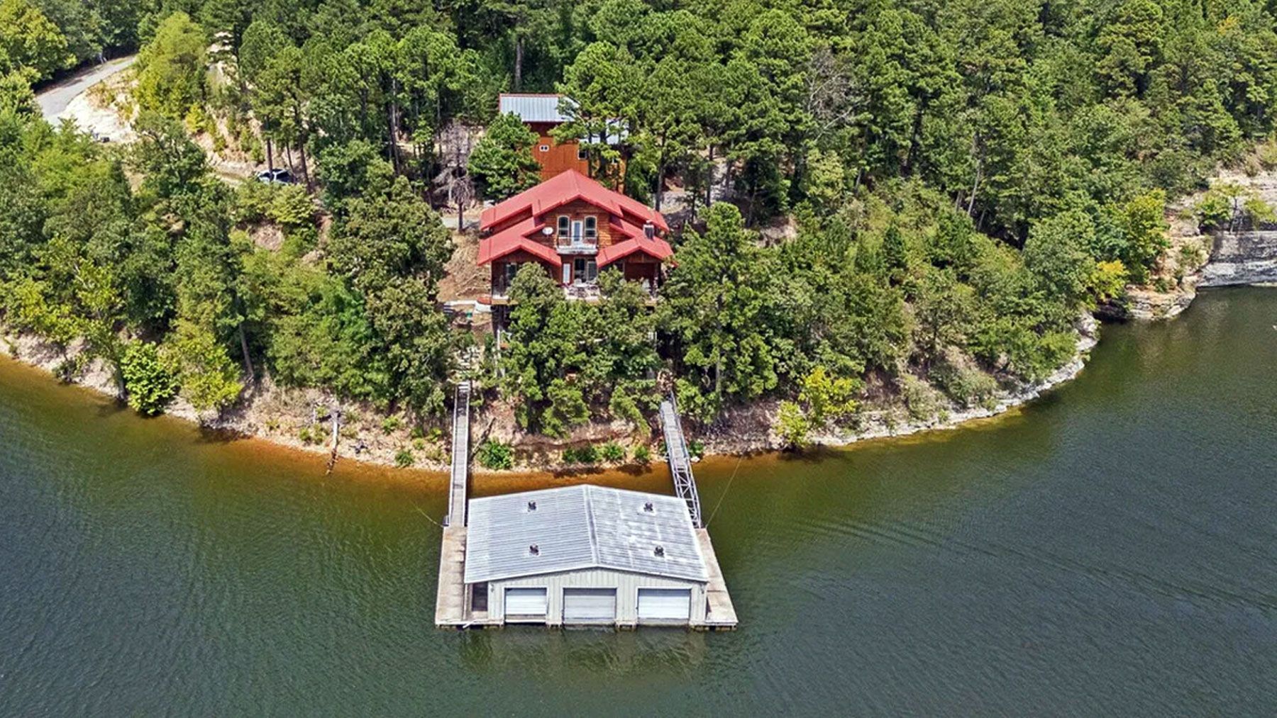 Aerial view of Grand Lake shoreline homes with docks and prepared for sale at auction