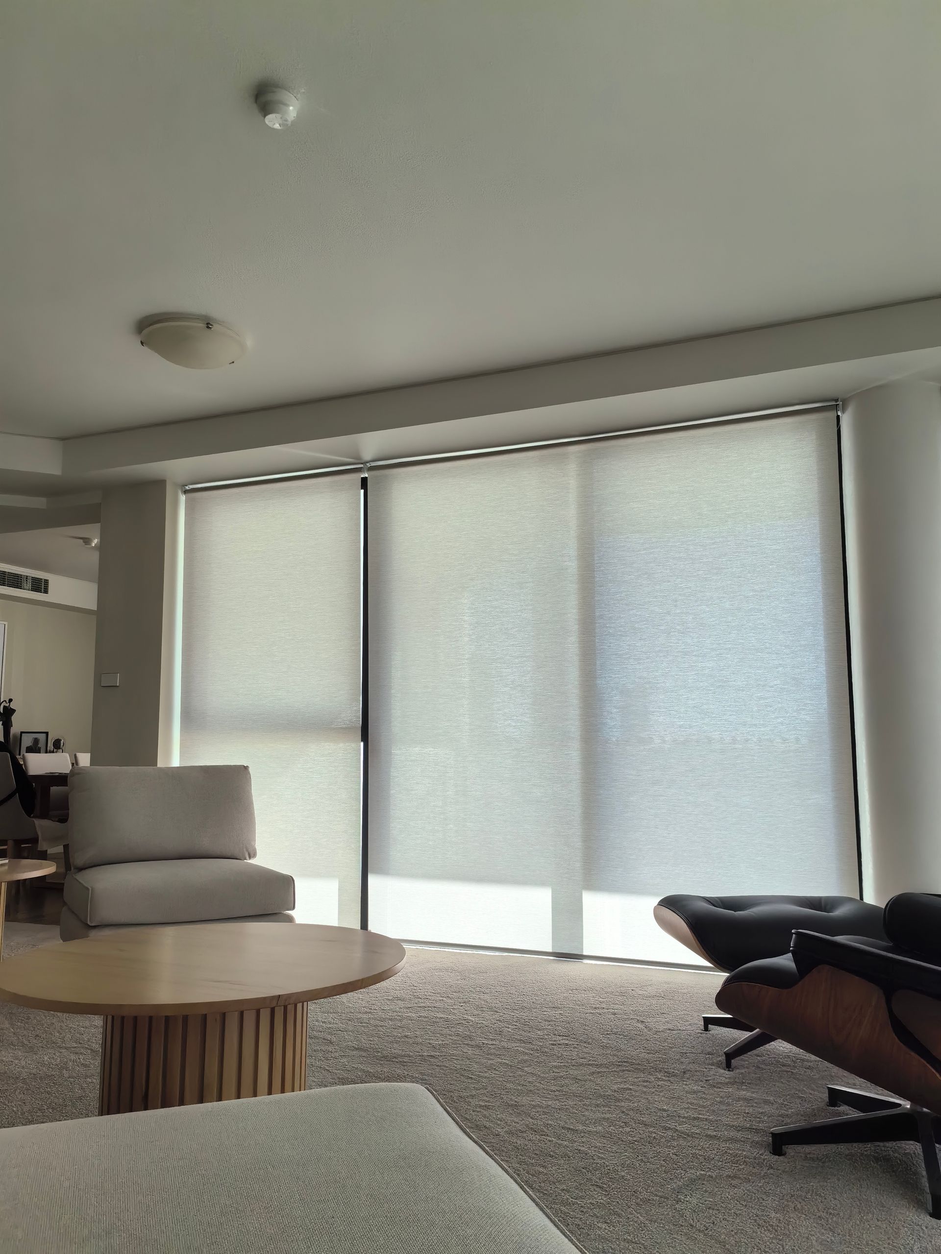 A living room with a table a chair and a couch