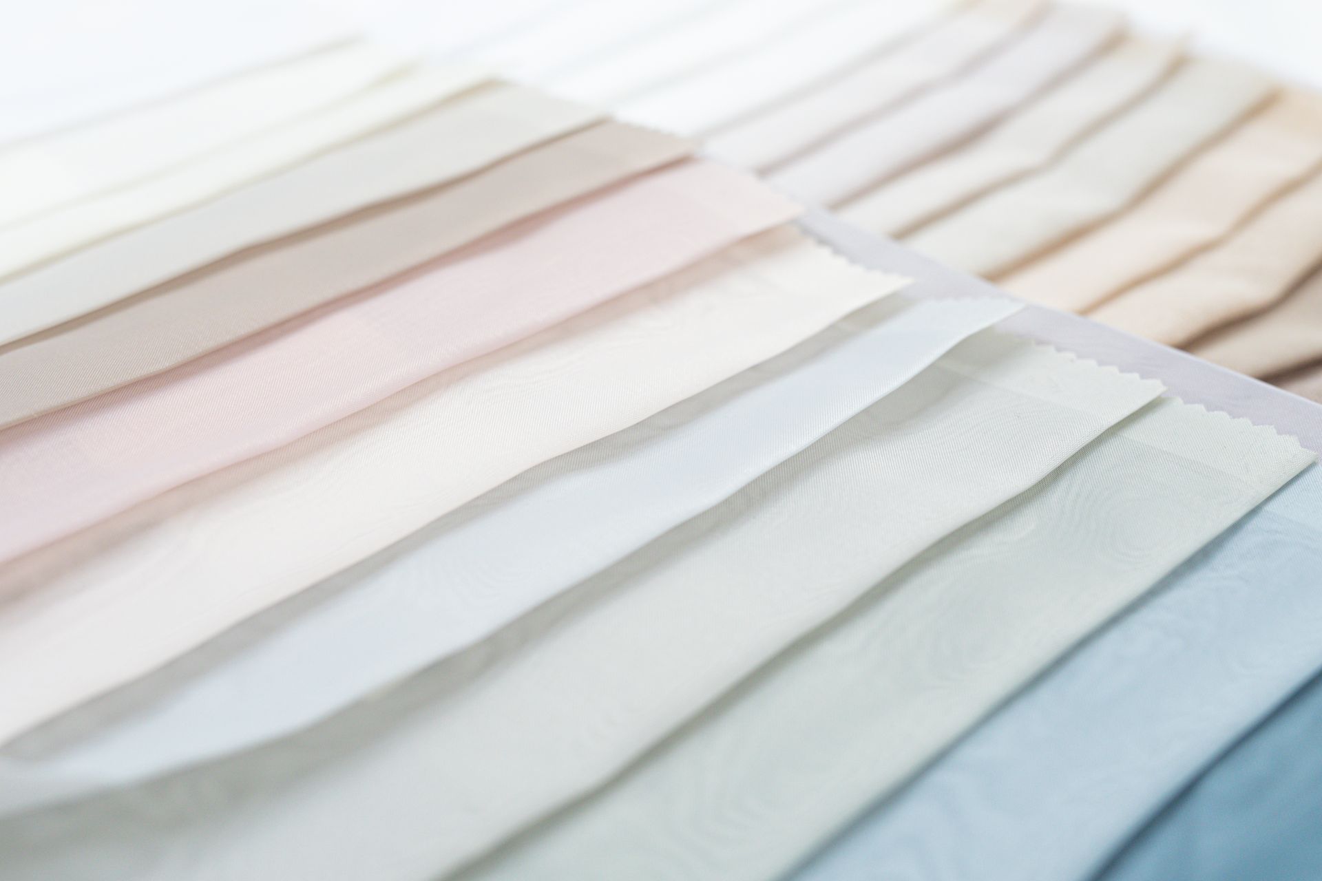 A close up of a bunch of different colored fabrics on a table.