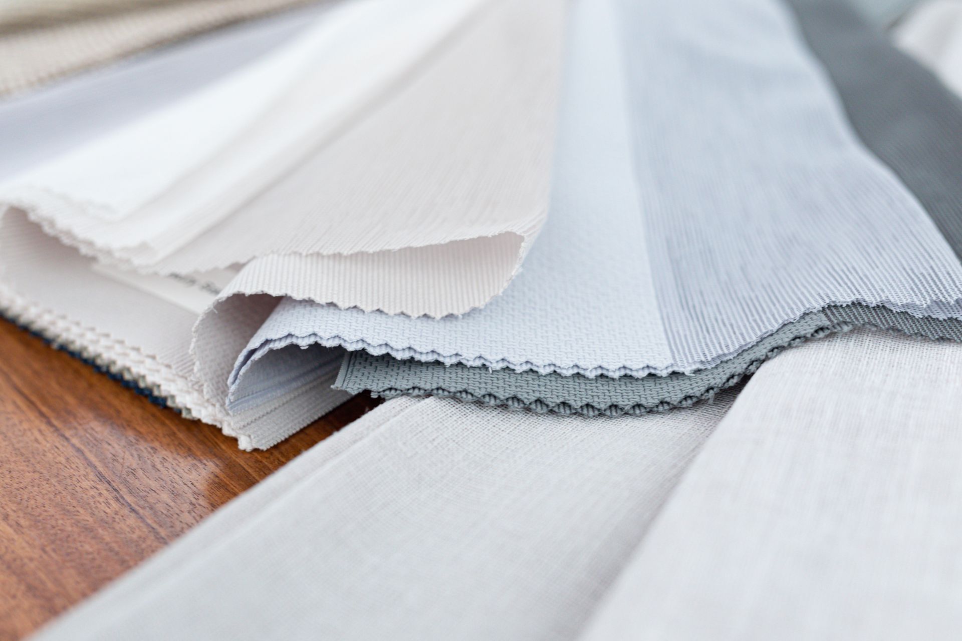 A close up of a pile of fabric on a wooden table.