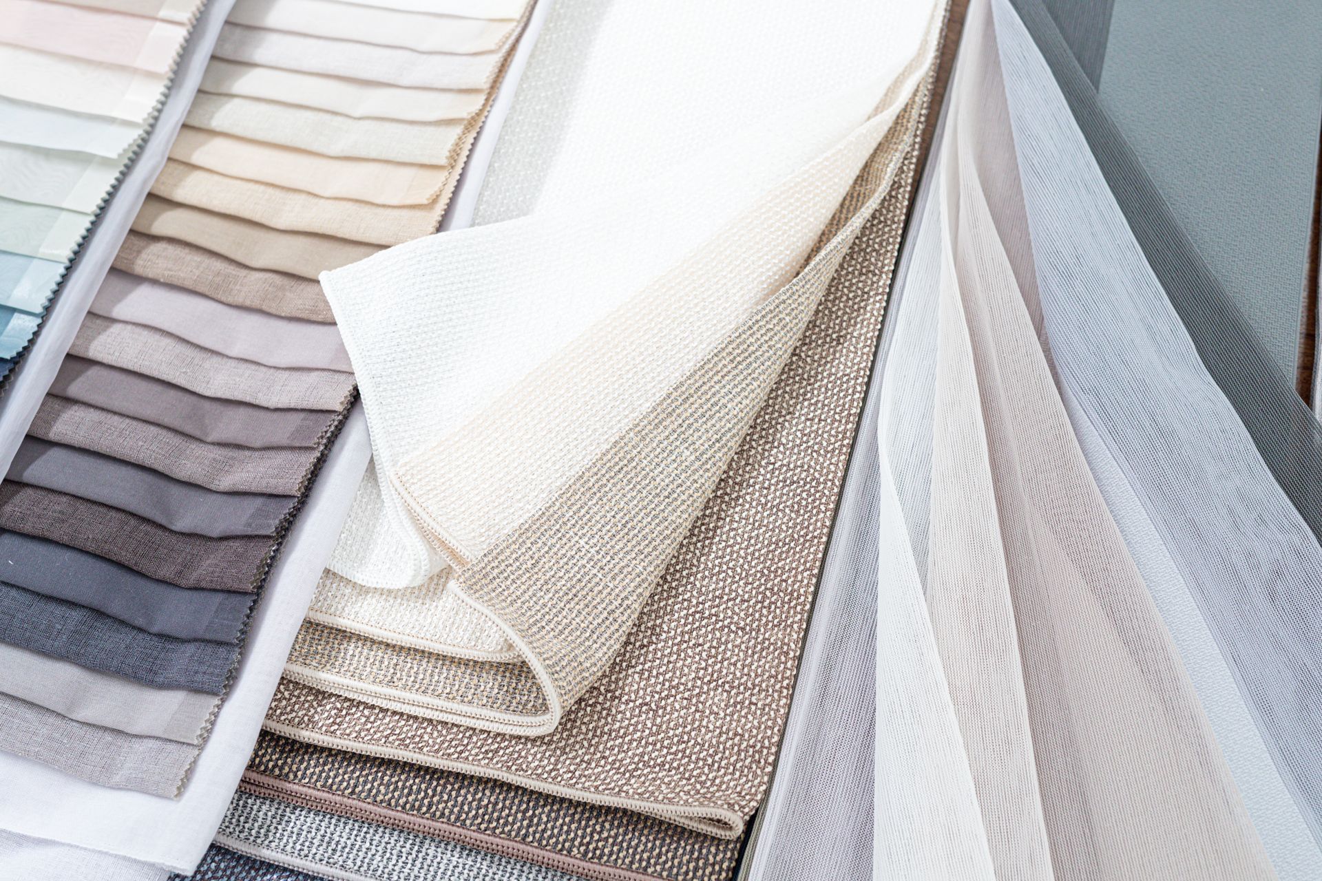 A bunch of different colored fabrics are stacked on top of each other