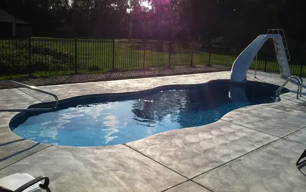 A large swimming pool with a slide attached to it