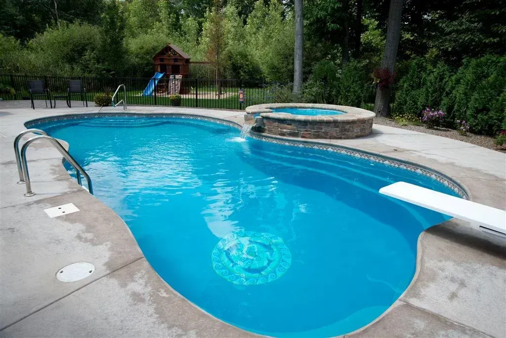 A large swimming pool with a diving board in the middle