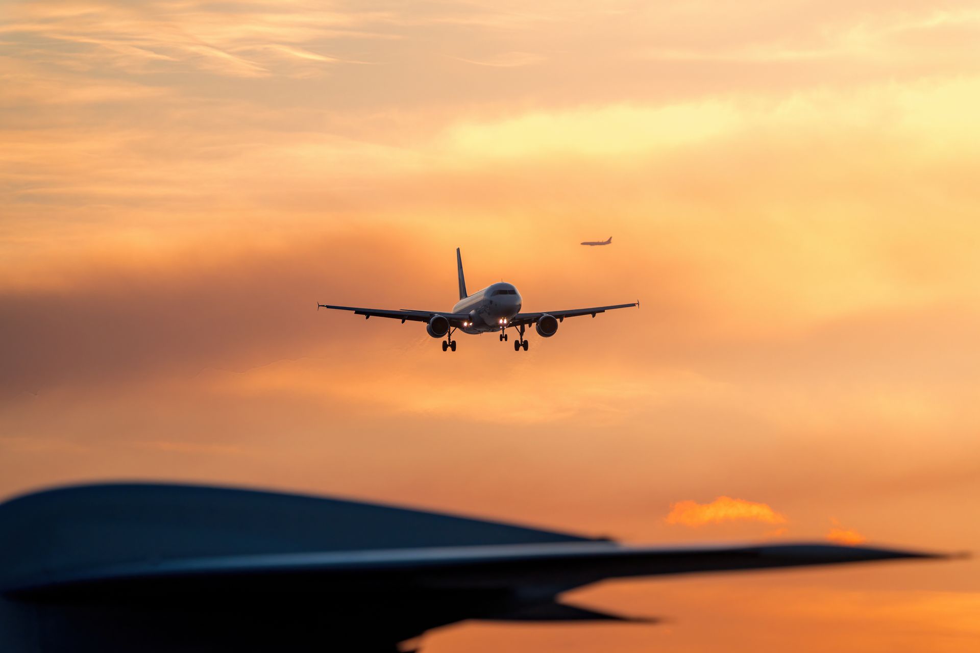 Airplane landing at sunset Airplane landing at sunset