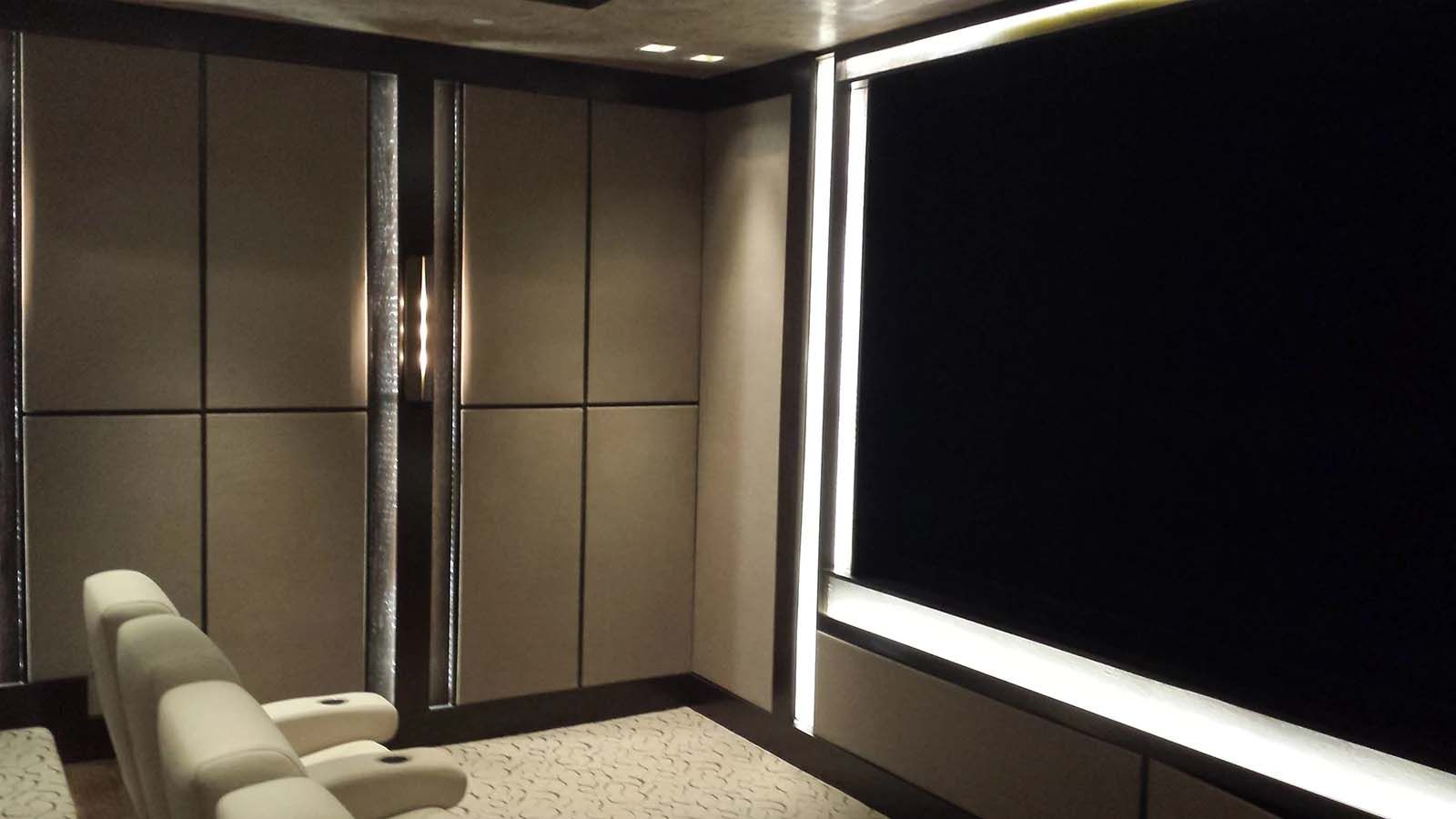 A room with a chair and a projector screen