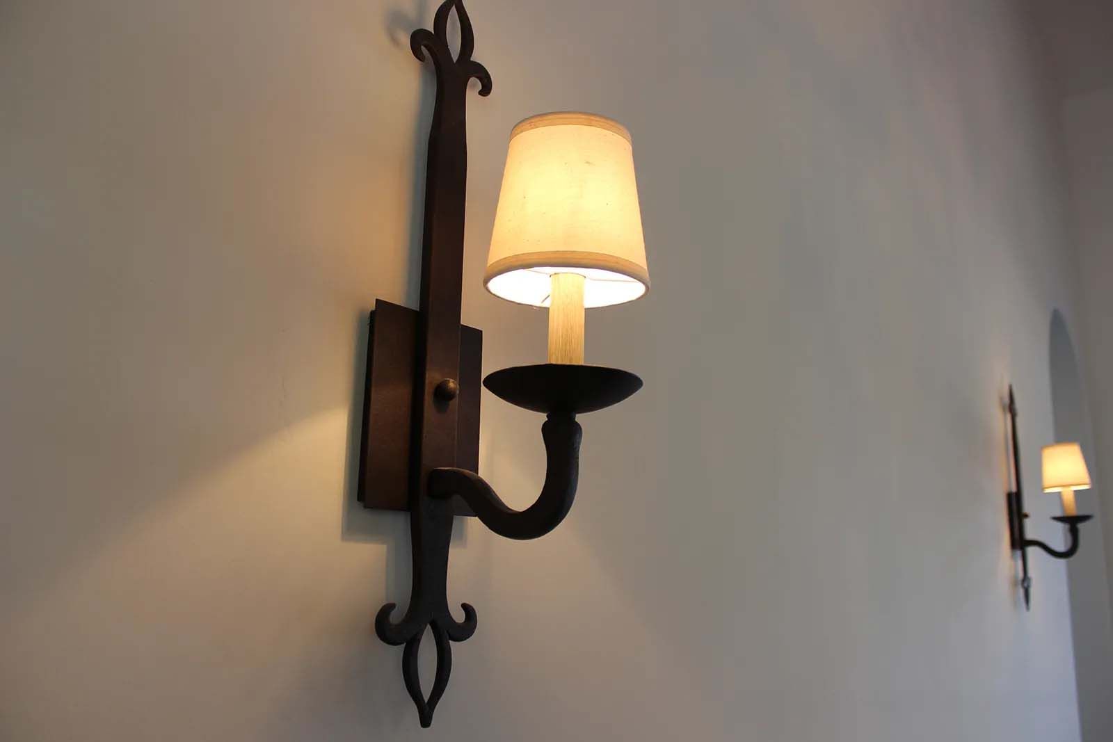A wall light with a candle on it