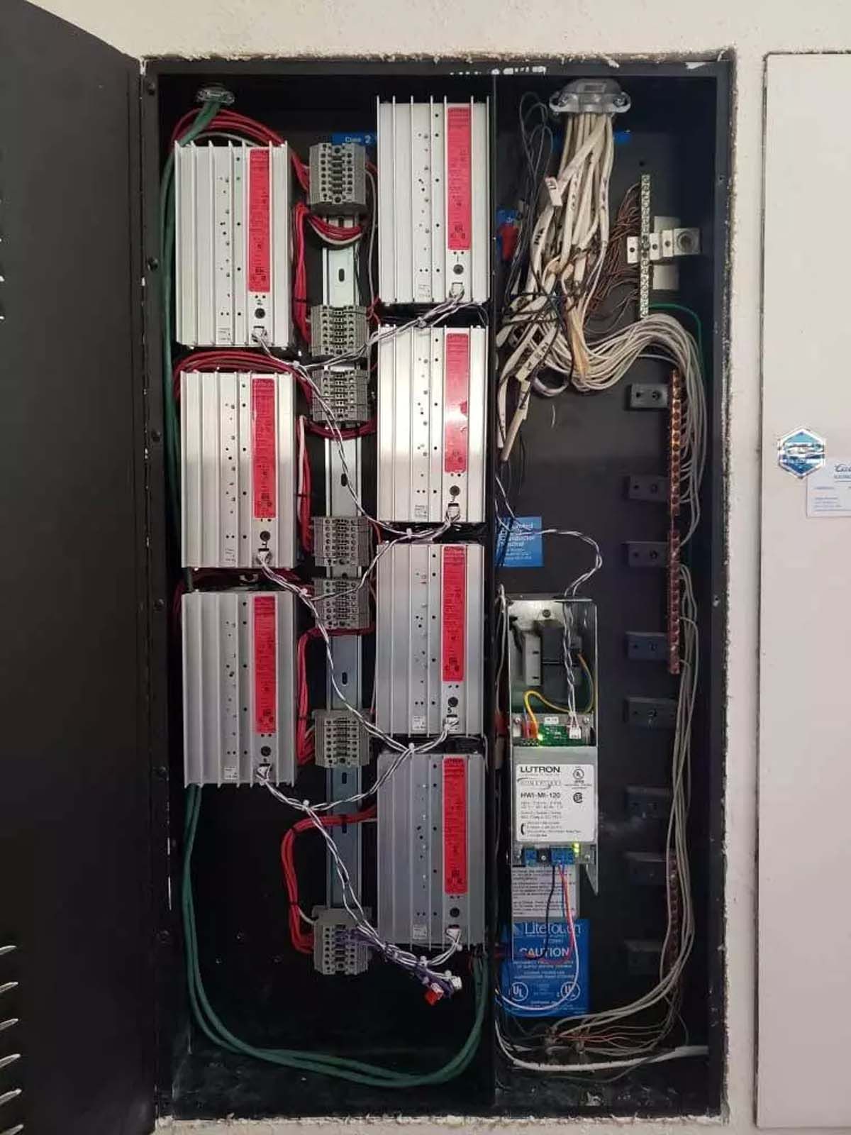 A electrical box with a lot of wires coming out of it.