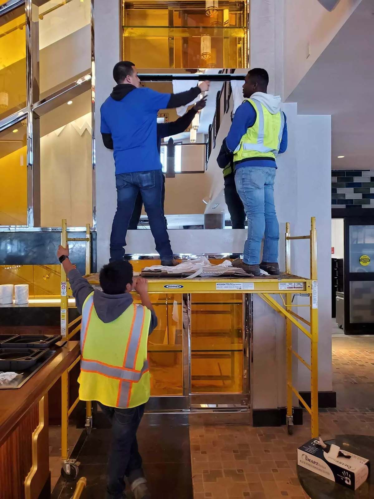 A group of construction workers are working on a staircase.