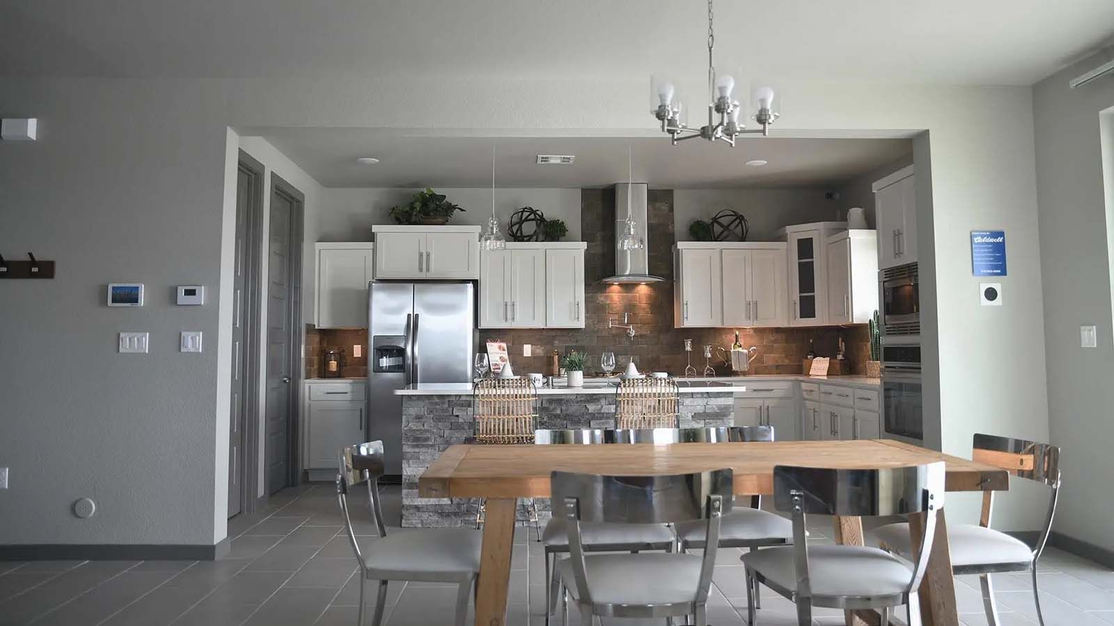 A kitchen with a table and chairs in it