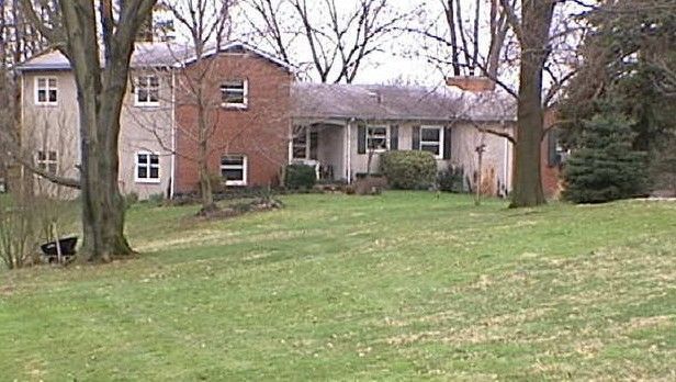 Two-story house in winter, beige siding with brick, snow on the ground, evergreen tree, and a truck in the driveway. Two-story house in winter, beige siding with brick, snow on the ground, evergreen tree, and a truck in the driveway.