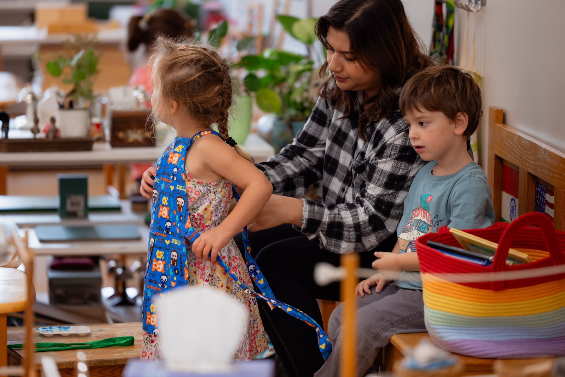 Montessori guide and children in classroom