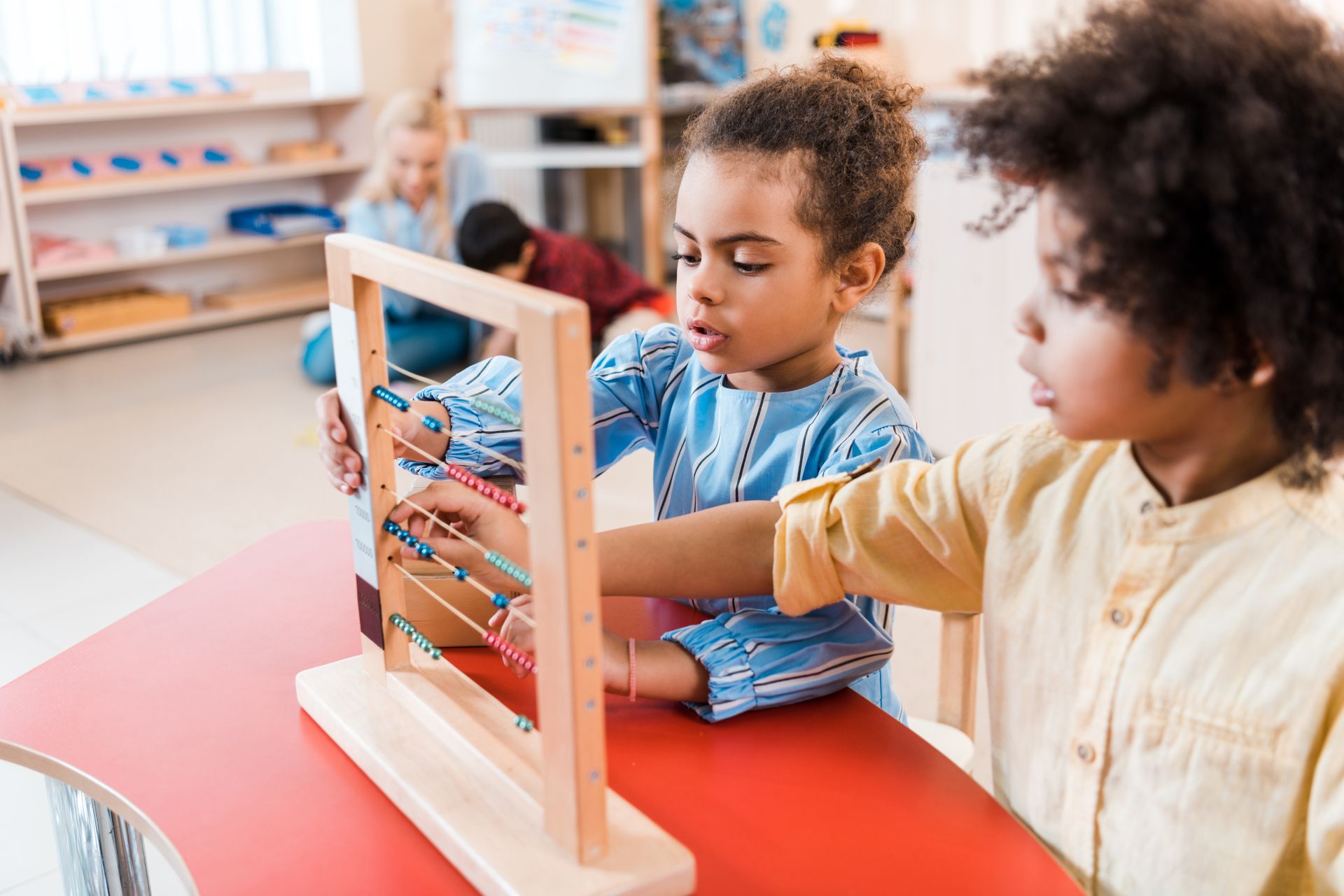 Montessori children of different ages seating on a dock