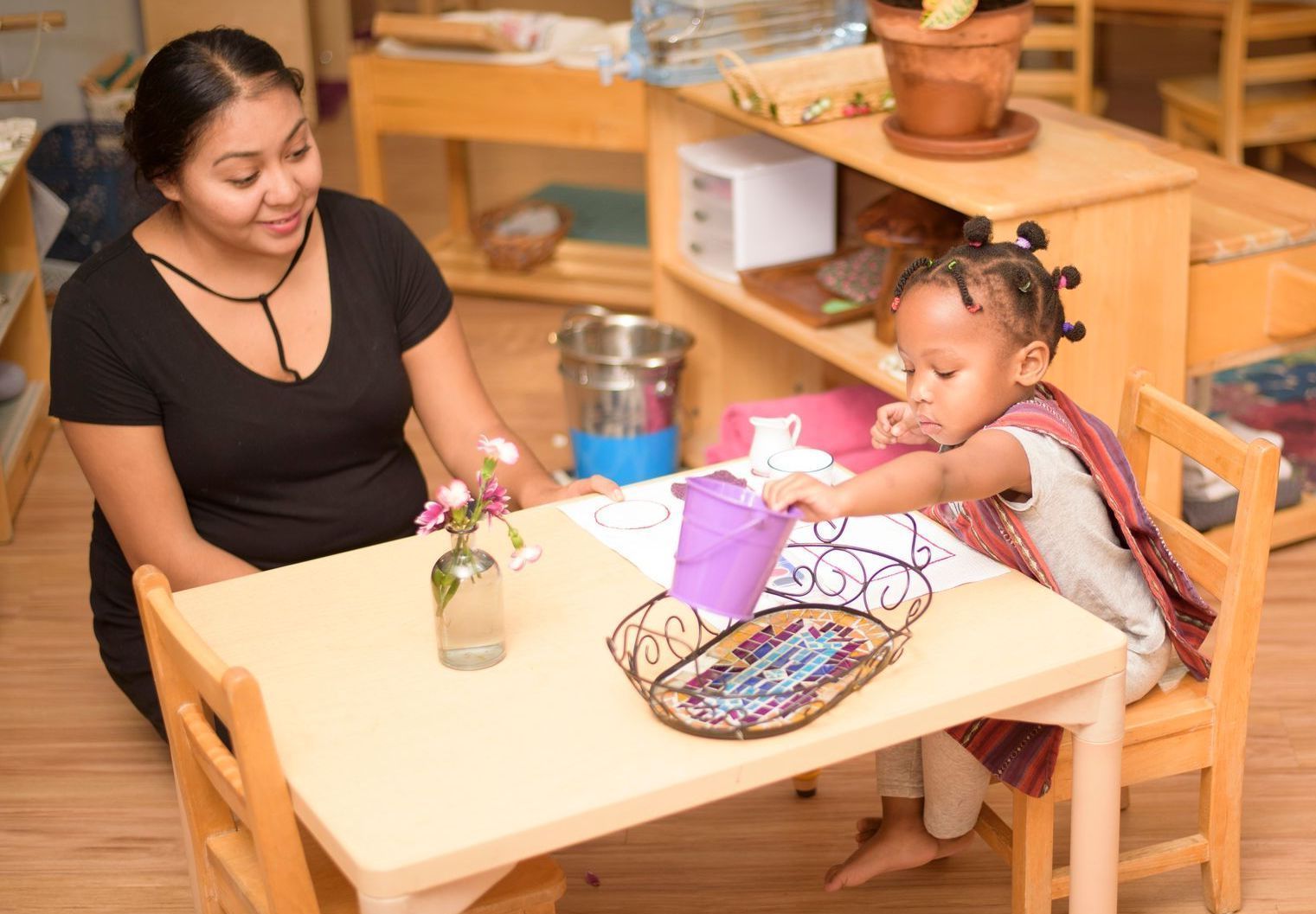 Child and guide in a Montessori classroom