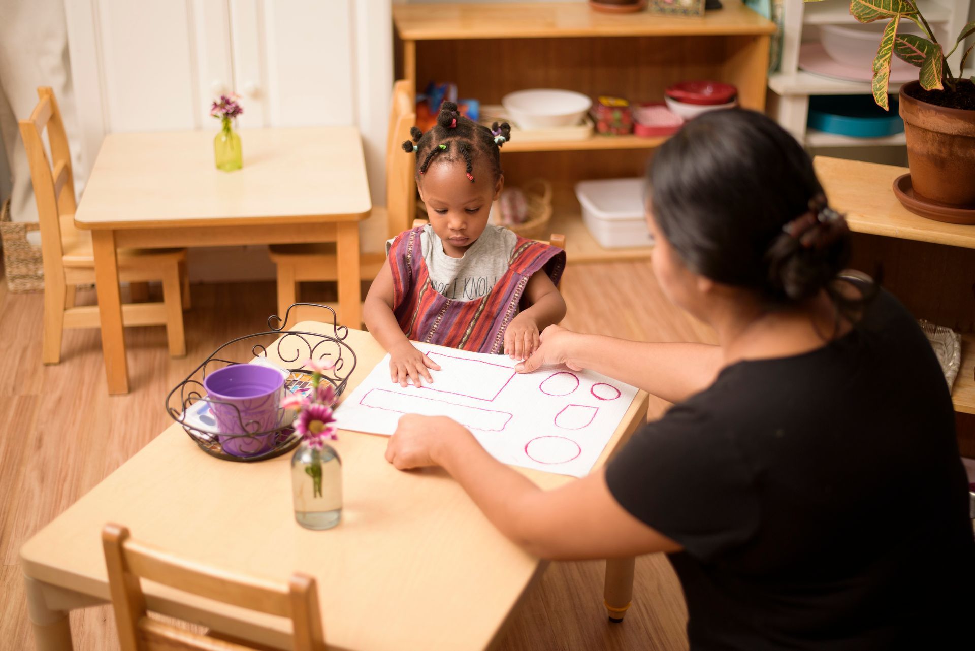 Montessori guide assisting child