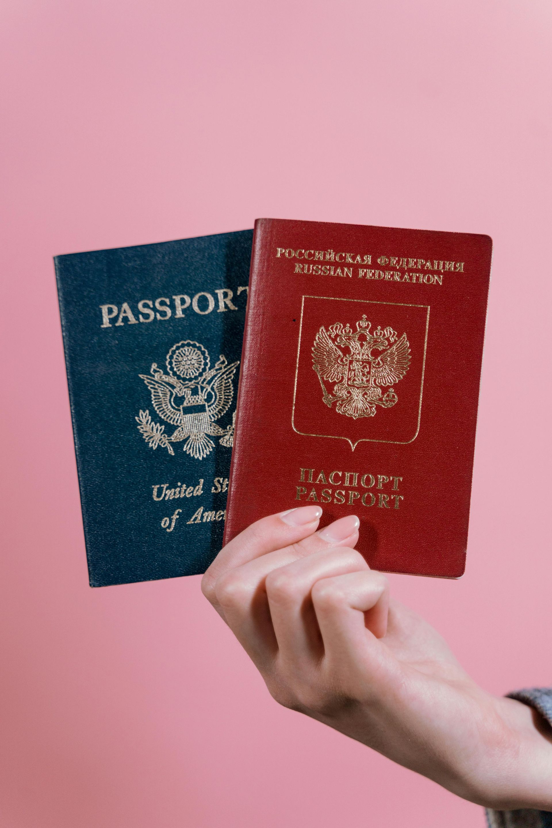 A person is holding two passports in their hands.