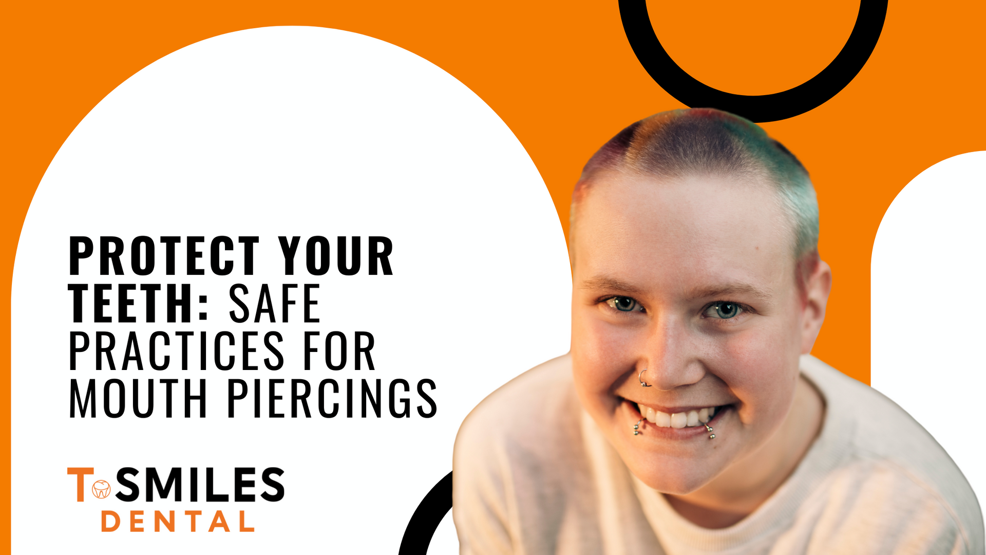A woman with a shaved head is smiling in front of an orange background.