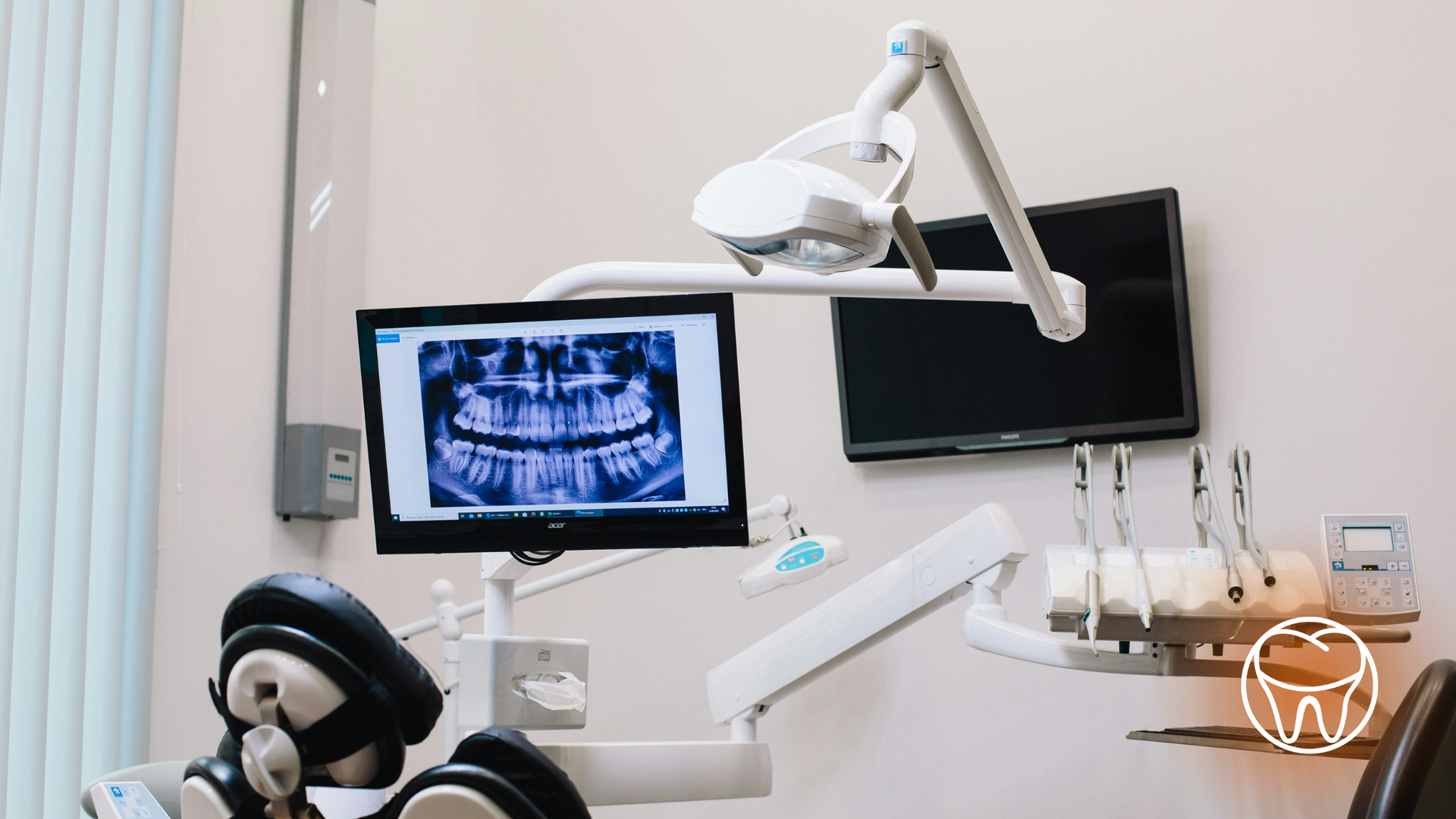A teddy bear is sitting in a dental chair in a dental office.