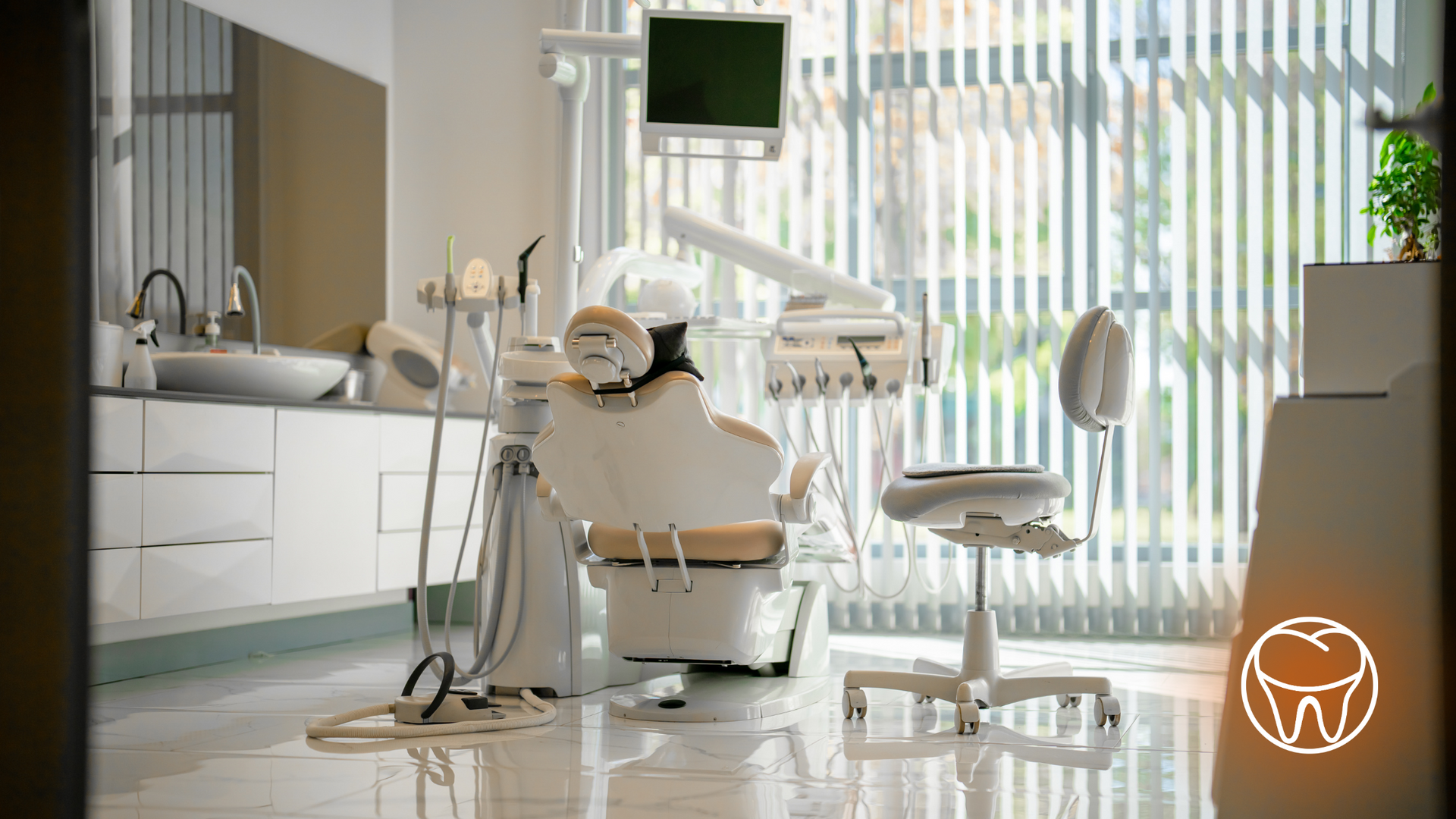 A dental office with a dental chair and a sink.