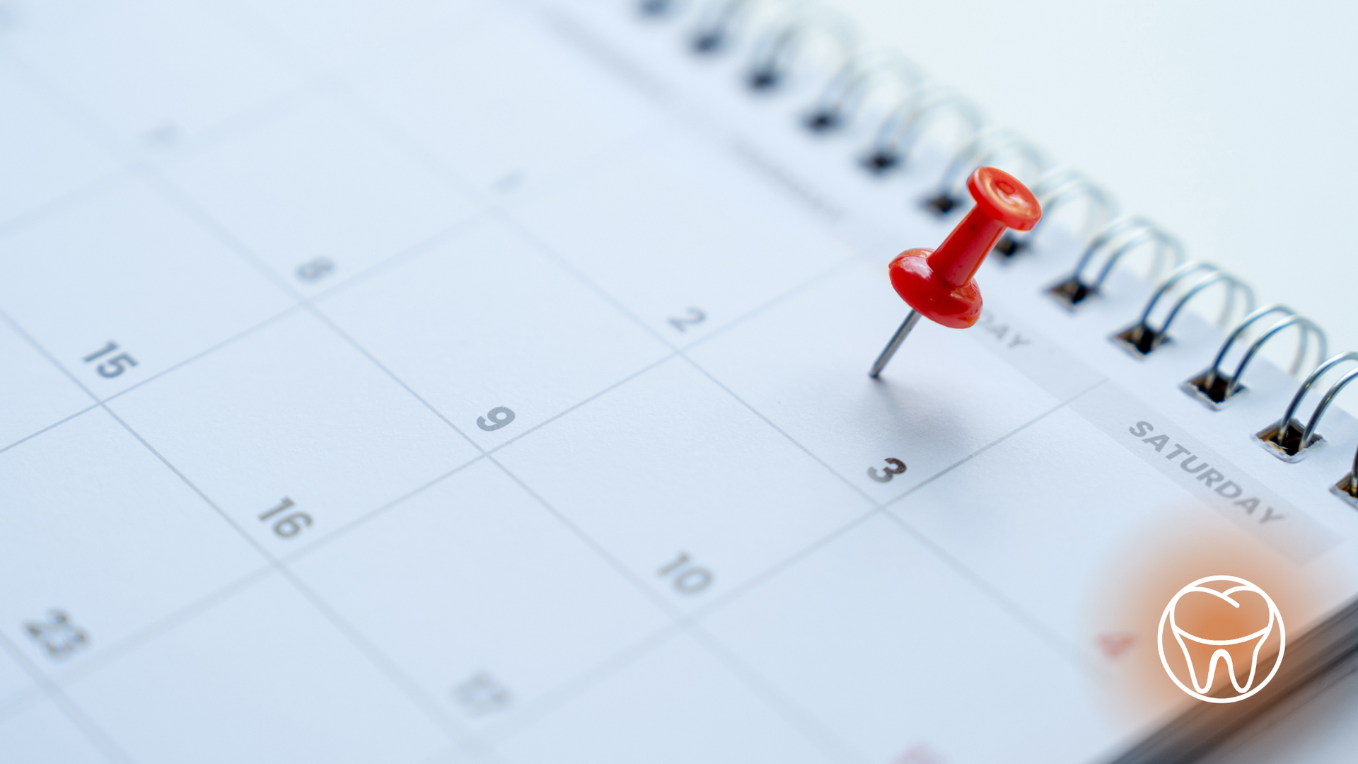 A calendar with a red pin on the date of saturday
