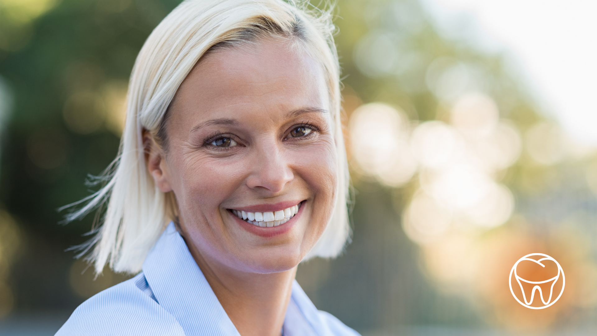 A woman with blonde hair is smiling for the camera.