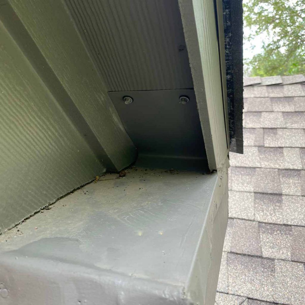 A close up of a roof with a gutter on it.