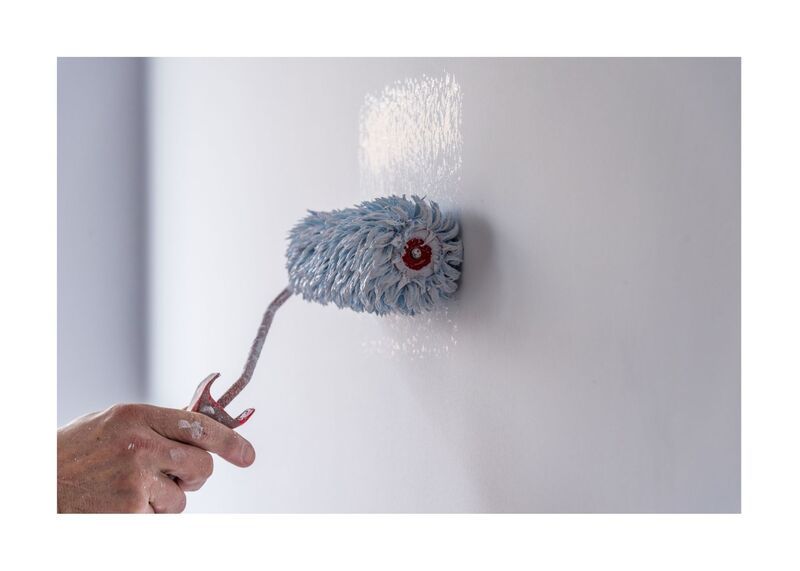 New West Paint roller on wall up close