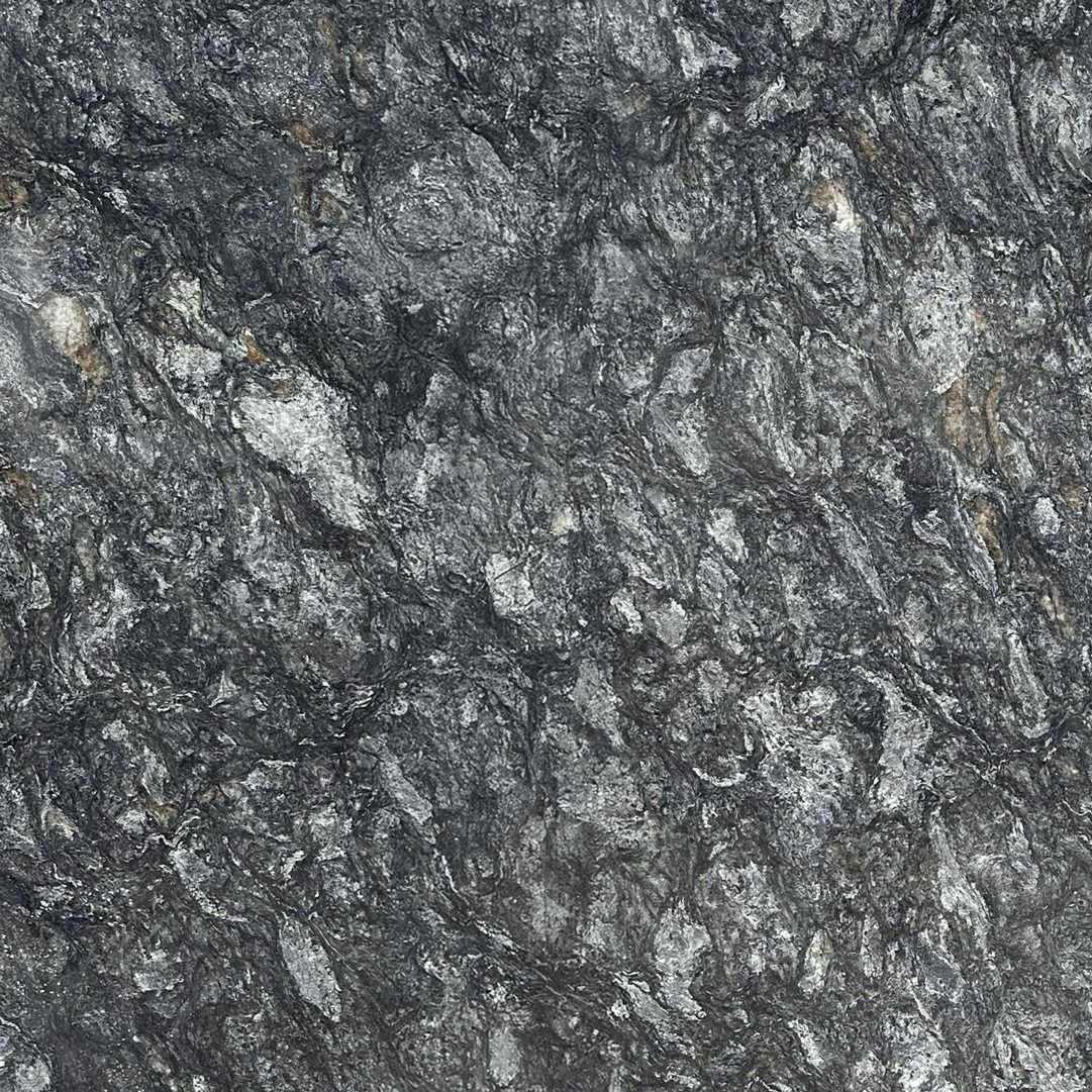 Close-up of rough gray and black stone texture with speckled white flecks