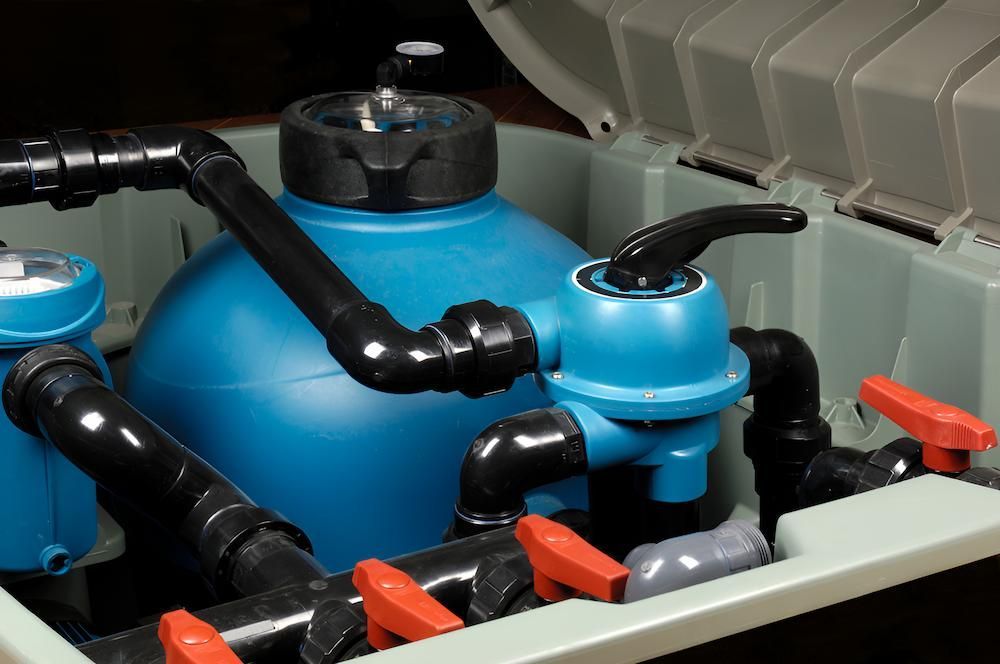 A Swimming Pool Filter is Sitting Inside of a Box With the Lid Open — Sun City Pools In Hyde Park, QLD