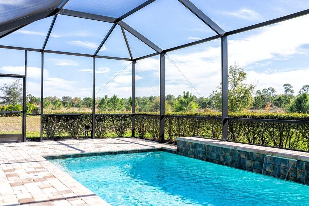 A Swimming Pool With a Blue Cover on the Side of It — Sun City Pools In Hyde Park, QLD