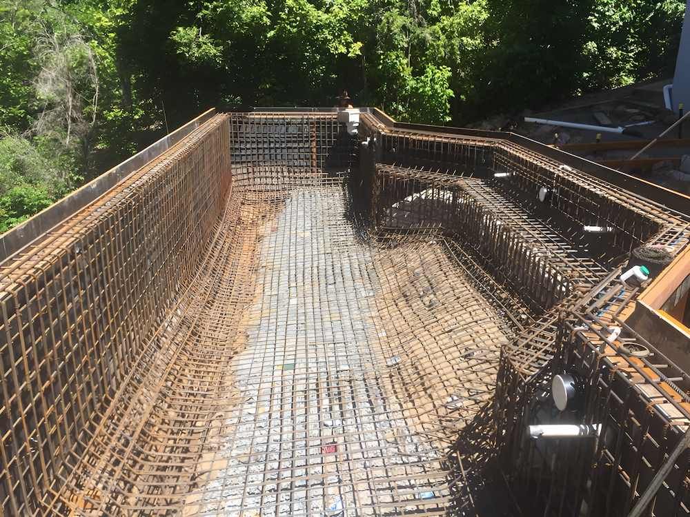 A Large Swimming Pool is Being Built in a Backyard— Sun City Pools In Hyde Park, QLD