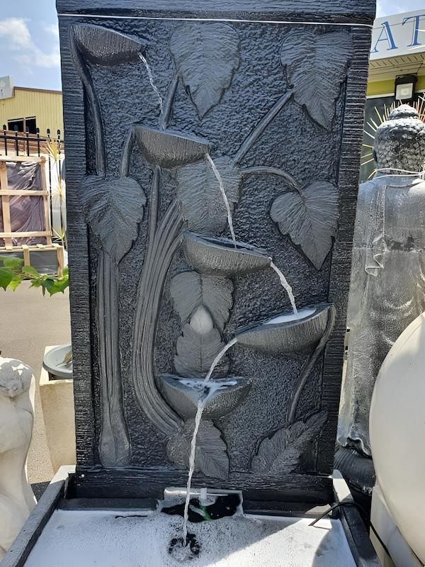A Water Fountain With a Statue in the Background is Sitting on a Table — Sun City Pools In Hyde Park, QLD