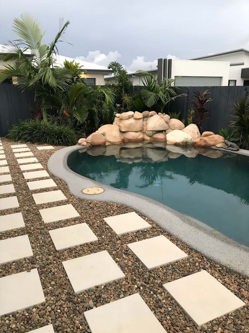 There is a Large Swimming Pool in the Backyard of a House — Sun City Pools In Hyde Park, QLD