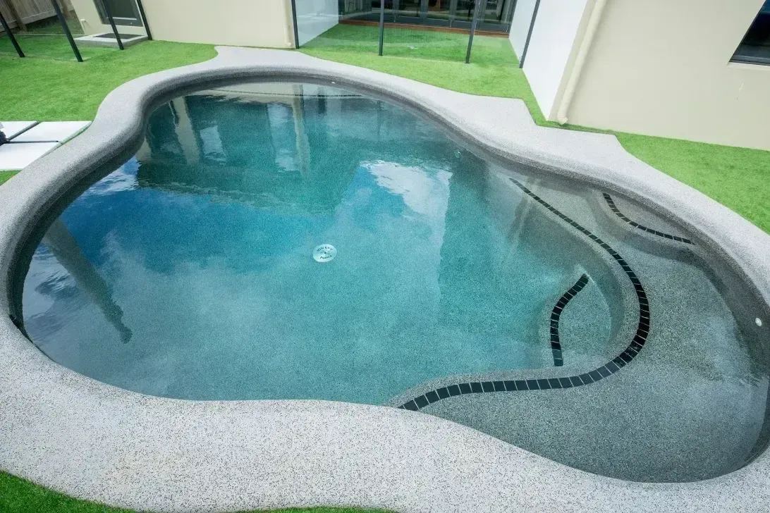 A Small Swimming Pool in the Backyard of a House — Sun City Pools In Hyde Park, QLD