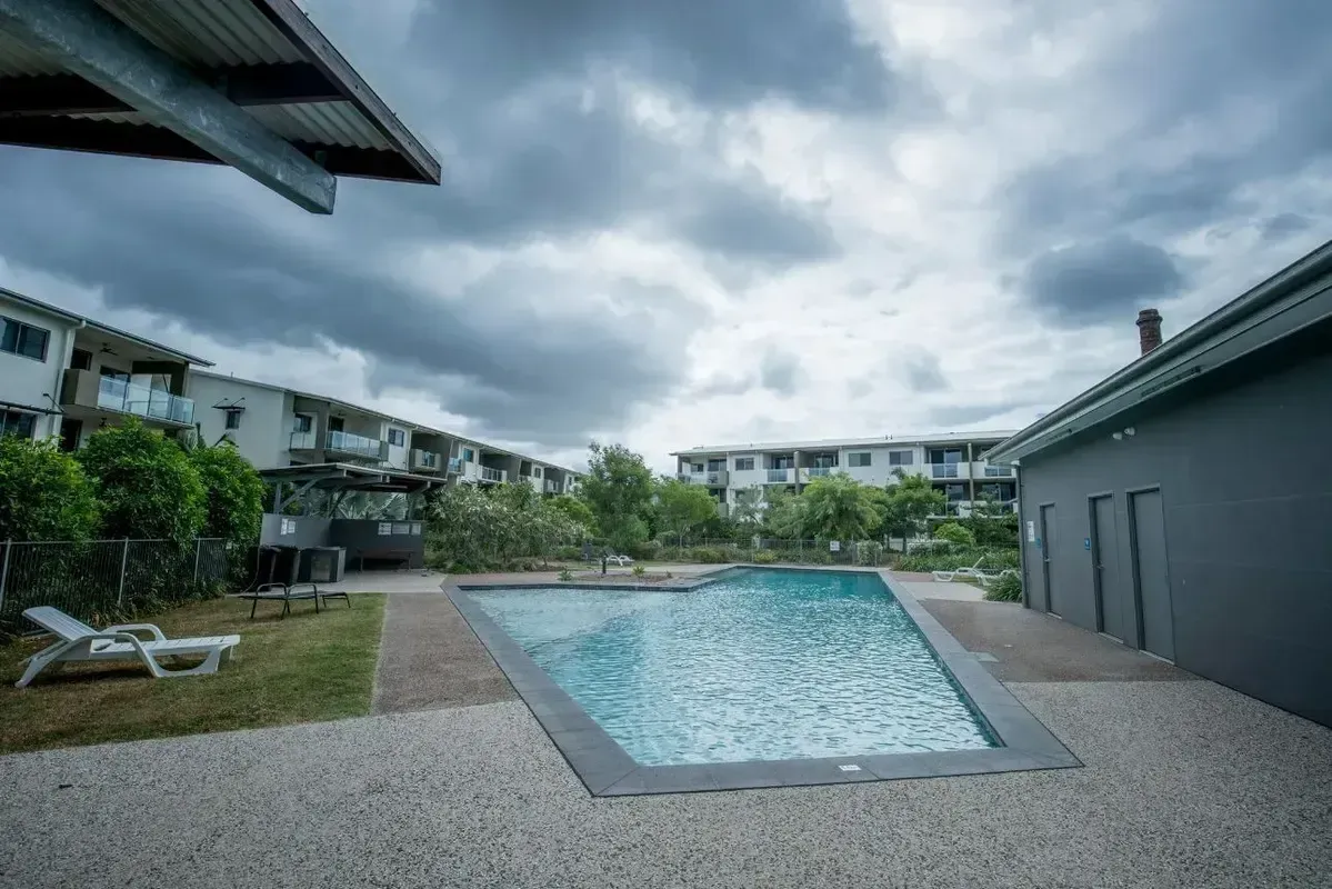 There is a Large Swimming Pool in the Backyard of a House — Sun City Pools In Hyde Park, QLD