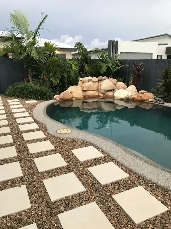 A Swimming Pool With a Walkway Leading to It — Sun City Pools In Hyde Park, QLD