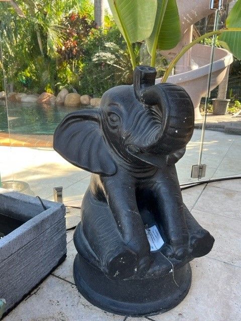 A Black Statue of an Elephant is Sitting on a Patio Next to a Pool — Sun City Pools In Hyde Park, QLD