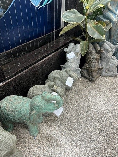 A Statue of an Elephant Sitting on a Rock in a Room — Sun City Pools In Hyde Park, QLD