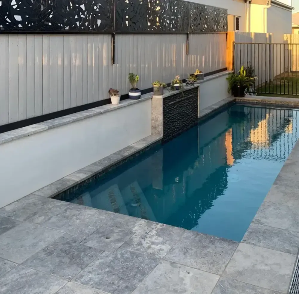 A Large Swimming Pool With a Fence Surrounding It — Sun City Pools In Kirwan, QLD