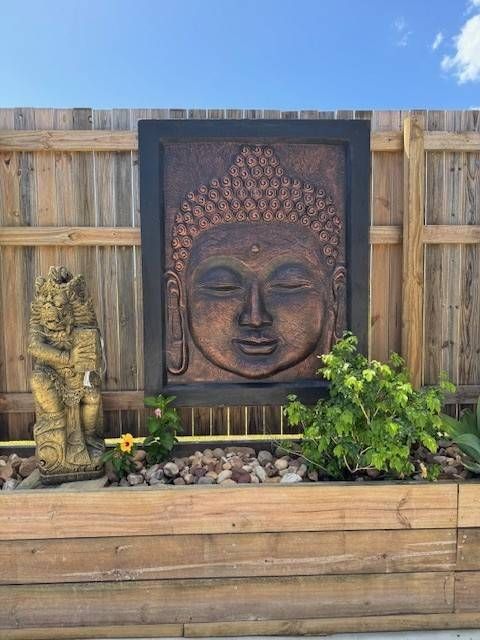 Balinese Wall décor In the Garden with a Buddha Statue — Sun City Pools In Hyde Park, QLD