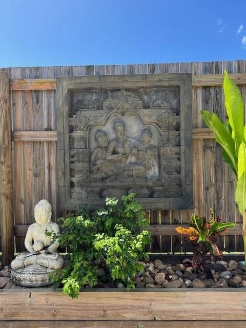Balinese Wall décor In the Garden with a Buddha Statue — Sun City Pools In Hyde Park, QLD